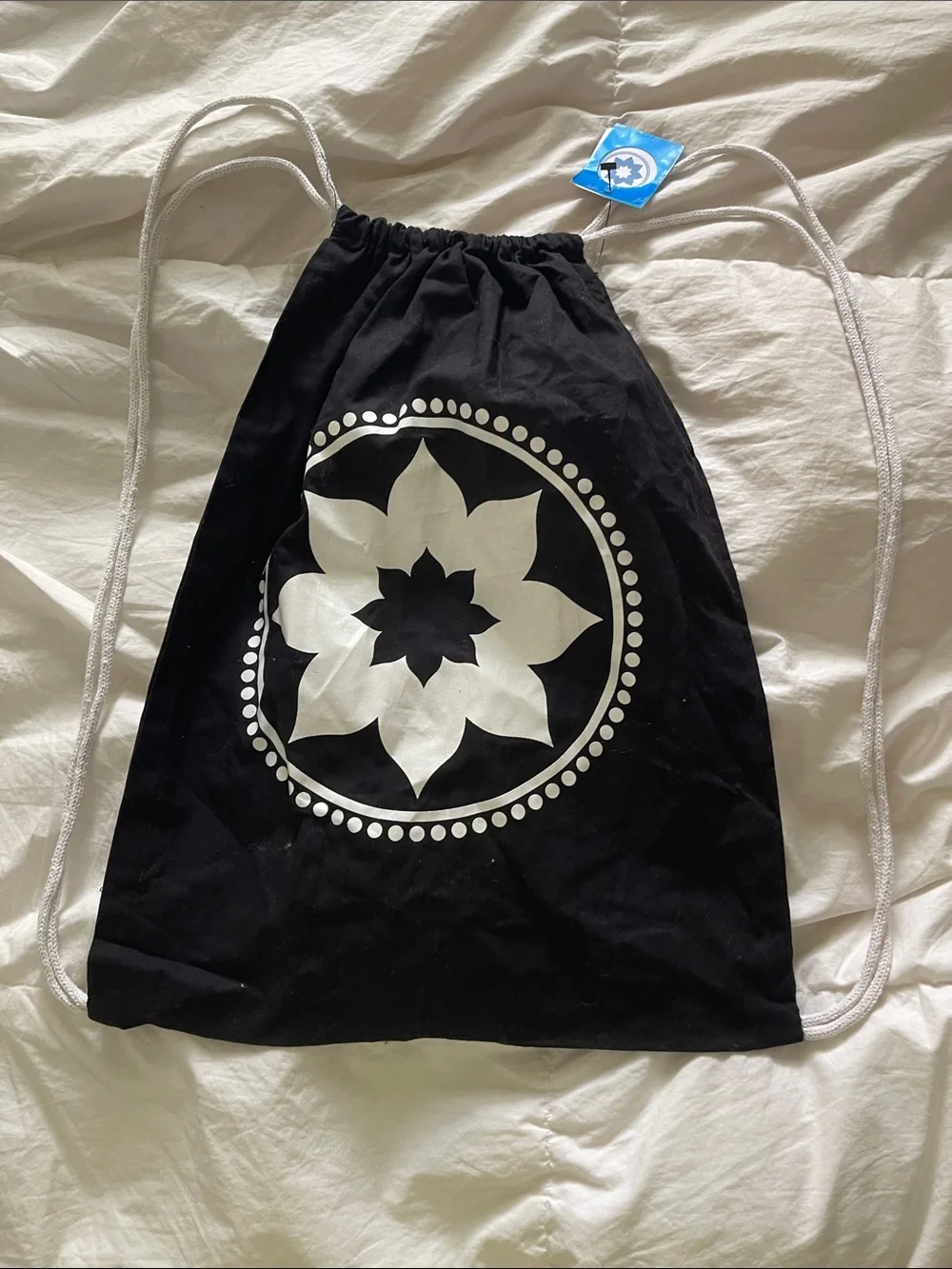 Black Drawstring Backpack with White Floral Medallion